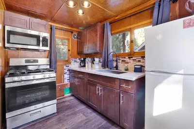 a kitchen with wooden cabinets and a white refrigerator at Big pines #103 in Big Bear Lake
