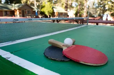 two tennis rackets and a ball on a tennis court at Big pines #103 in Big Bear Lake