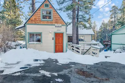a tiny house with a red door in the snow at Fawnskin pines #2259 in Fawnskin