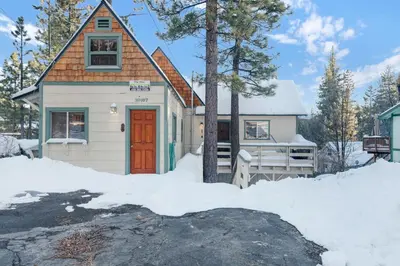 a tiny house with a red door in the snow at Fawnskin pines #2259 in Fawnskin