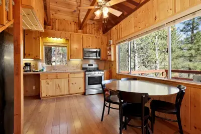 a kitchen with a table and chairs in a cabin at Fawnskin pines #2259 in Fawnskin