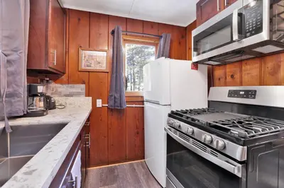 a kitchen with a white refrigerator and a stove at Little pines #102 in Big Bear Lake