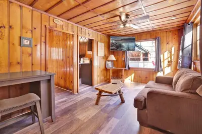 a living room with a couch and a table at Little pines #102 in Big Bear Lake