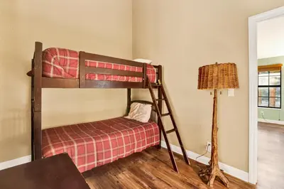 a bedroom with a bunk bed and a lamp at Fawnskin Chalet#1826 in Fawnskin
