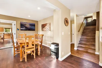 a dining room and living room with a table and chairs at Fawnskin Chalet#1826 in Fawnskin