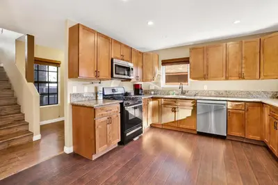 a kitchen with wooden cabinets and stainless steel appliances at Fawnskin Chalet#1826 in Fawnskin