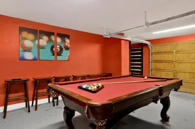 a pool table in a room with orange walls at Fawnskin Chalet#1826 in Fawnskin