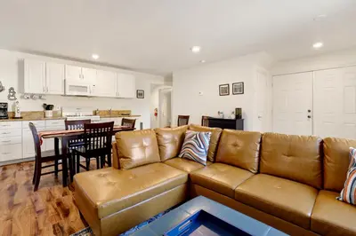 a living room with a brown couch and a kitchen at The weekender #2342 in Big Bear City