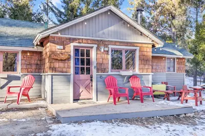 a tiny house with red chairs and a pink door at Lakeview #104 in Big Bear Lake