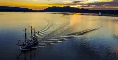 a boat in the water at sunset with its wake at Lakeview #104 in Big Bear Lake