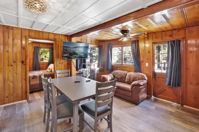 a dining room with a table and a couch at Lakeview #104 in Big Bear Lake