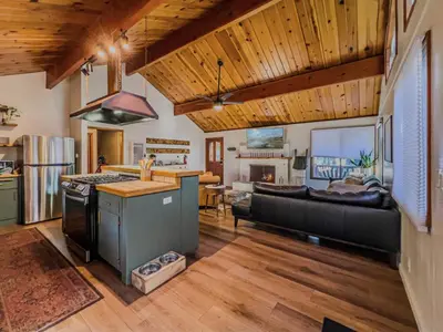 a kitchen and living room with wooden ceilings at The lost compass #2165 in Big Bear Lake