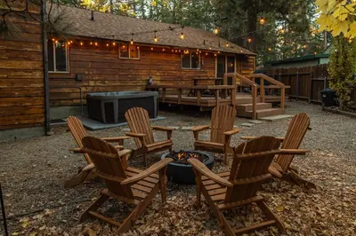 a backyard with chairs and a fire pit and a cabin at The lost compass #2165 in Big Bear Lake
