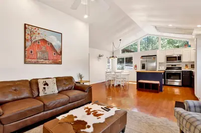 a living room with a brown couch and a kitchen at Mountain modern #1743 in Big Bear Lake