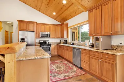 a large kitchen with wooden cabinets and stainless steel appliances at Eagle ridge views #1648 in Big Bear Lake
