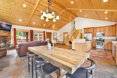 a kitchen and living room with a large wooden table at Eagle ridge views #1648 in Big Bear Lake