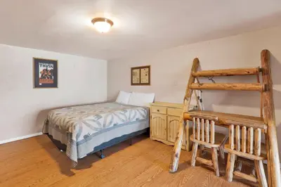 a bedroom with a bed and a ladder in it at Lake shore #012 in Big Bear Lake