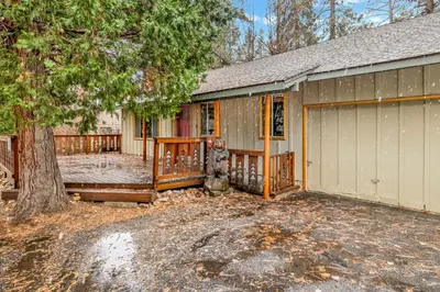 a house with a garage and a tree at Timber pines chalet #2417 in Big Bear Lake