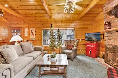 a living room with a couch and chairs and a tv at Timber pines chalet #2417 in Big Bear Lake