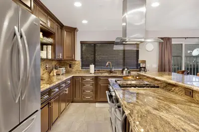 a kitchen with wooden cabinets and a stainless steel refrigerator at Majestic sky retreat #2090 in Big Bear Lake