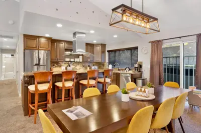 an open kitchen and dining room with a wooden table and chairs at Majestic sky retreat #2090 in Big Bear Lake