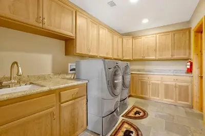a kitchen with a stainless steel refrigerator and wooden cabinets at Sunset ridge villa #2178 in Big Bear Lake
