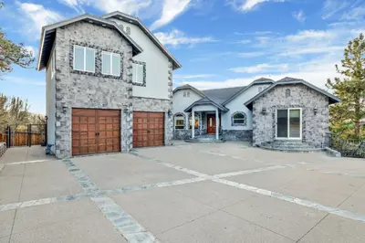 a stone house with a driveway at Sunset ridge villa #2178 in Big Bear Lake