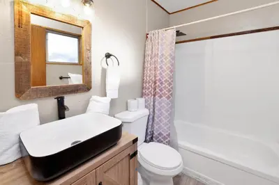 a bathroom with a sink and a toilet and a mirror at Lakefront #110 in Big Bear Lake