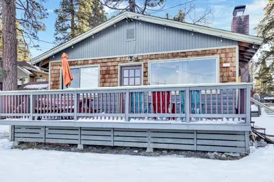 a tiny house with a deck in the snow at Lakefront #110 in Big Bear Lake