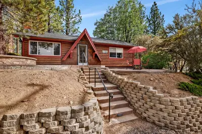 a home with a retaining wall and a house at Moulin rouge #2055 in Big Bear Lake