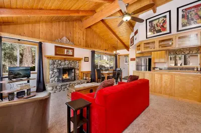 a living room with a red couch and a fireplace at Moulin rouge #2055 in Big Bear Lake