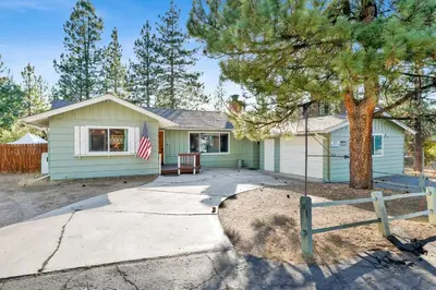 a green house with a tree in front of it at Mountain fun #1729 in Big Bear Lake