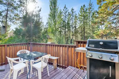 a deck with a grill and a table and chairs at Mountain fun #1729 in Big Bear Lake