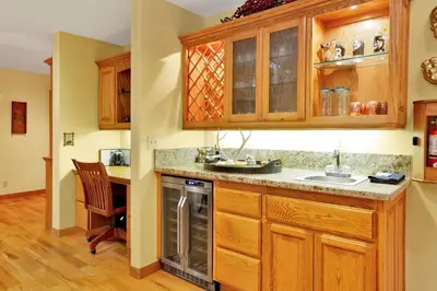 a kitchen with wooden cabinets and a sink at Flitterbick lodge #2246 in Fawnskin