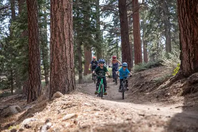 a group of people riding bikes down a dirt trail at Ski time getaway #1848 in Big Bear Lake