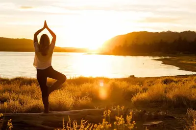 a woman doing yoga on a log near a body of water at Ski time getaway #1848 in Big Bear Lake