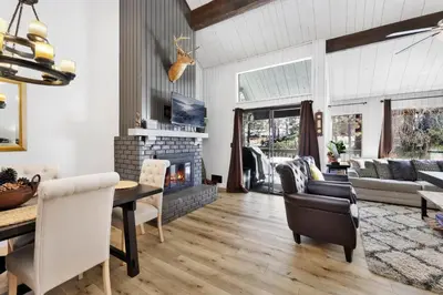 a living room with a fireplace and a table at Switzerland slopes #2125 in Big Bear Lake