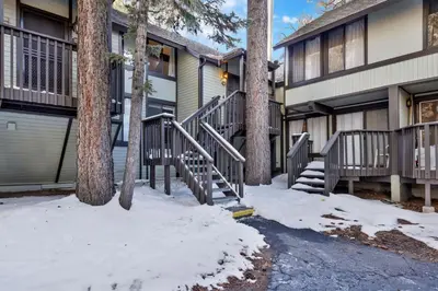 a house with stairs and trees in the snow at Switzerland slopes #2125 in Big Bear Lake