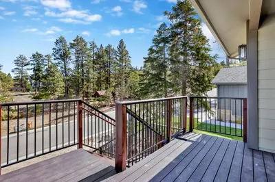 a balcony of a house with a wooden deck at The pines retreat #2336 in Big Bear Lake