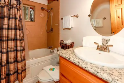 a bathroom with a sink and a tub and a toilet at Mountain adventure #1931 in Big Bear Lake