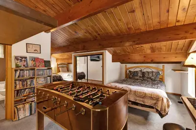 a bedroom with a bed and a large foosball table at Mountain adventure #1931 in Big Bear Lake