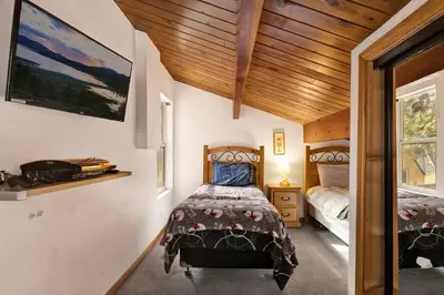 a bedroom with a bed in a room with wooden ceilings at Mountain adventure #1931 in Big Bear Lake