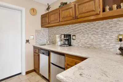 a kitchen with wooden cabinets and a counter top at Forest shores lake view condo #2250 in Big Bear Lake