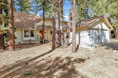 a white house with trees in front of it at All season alpine retreat #1184 in Big Bear Lake