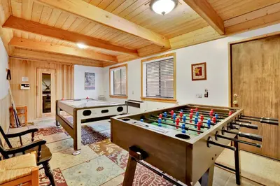 a living room with a pool table and a table at All season alpine retreat #1184 in Big Bear Lake