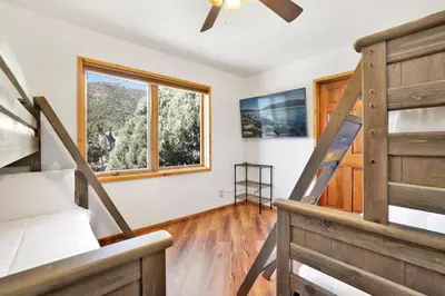 a bedroom with a bunk bed and a ladder at The octagon #2394 in Big Bear City