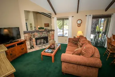a living room with a couch and a fireplace at Boulder creek #1412 in Big Bear Lake