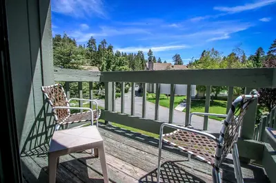 two chairs sitting on the porch of a house at Boulder creek #1412 in Big Bear Lake
