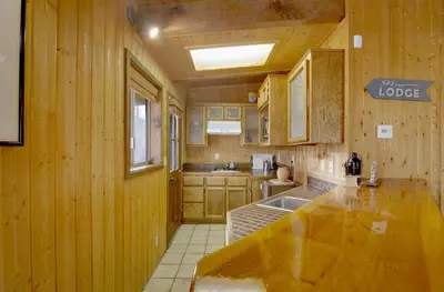 a kitchen with wooden walls and a large counter top at Switzerland ski chalet #845 in Big Bear Lake