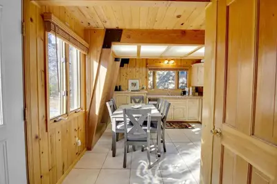 a dining room with a table and chairs in a kitchen at Switzerland ski chalet #845 in Big Bear Lake